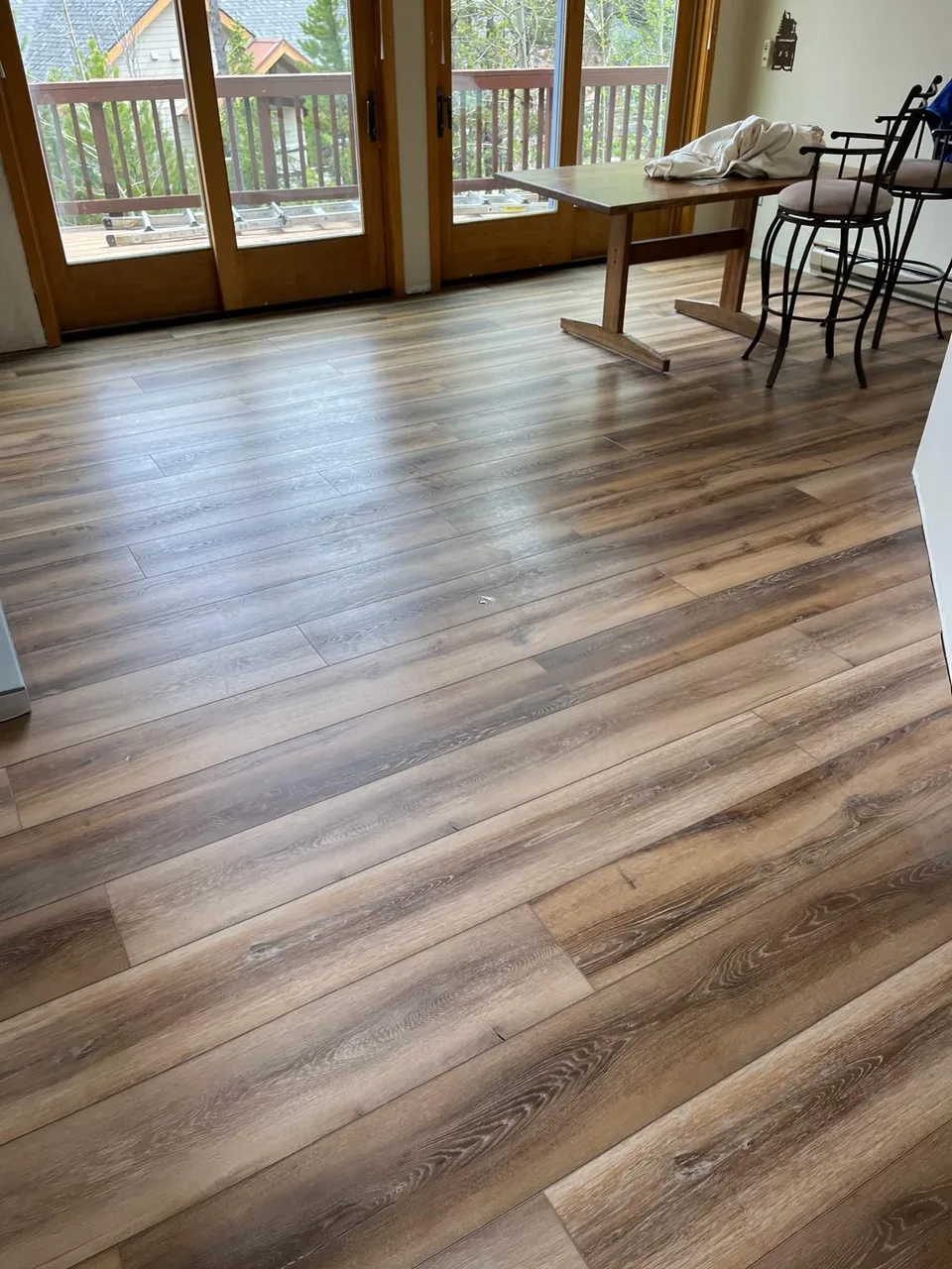 Wood flooring beside a row of sunroom windows