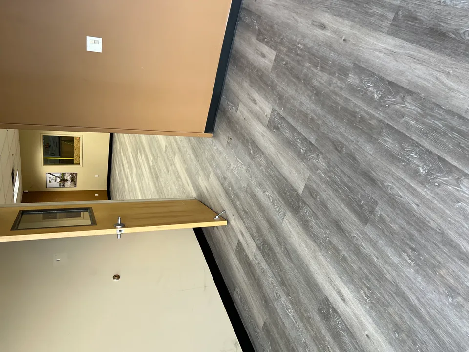 Gray plank flooring through a hallway