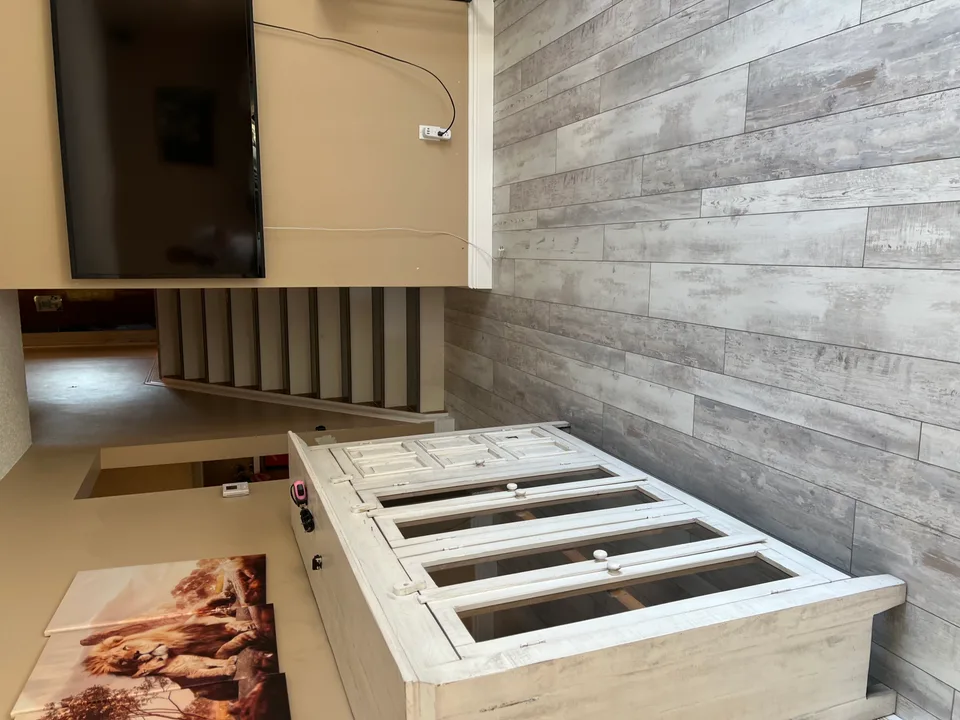 Gray plank flooring beside a staircase