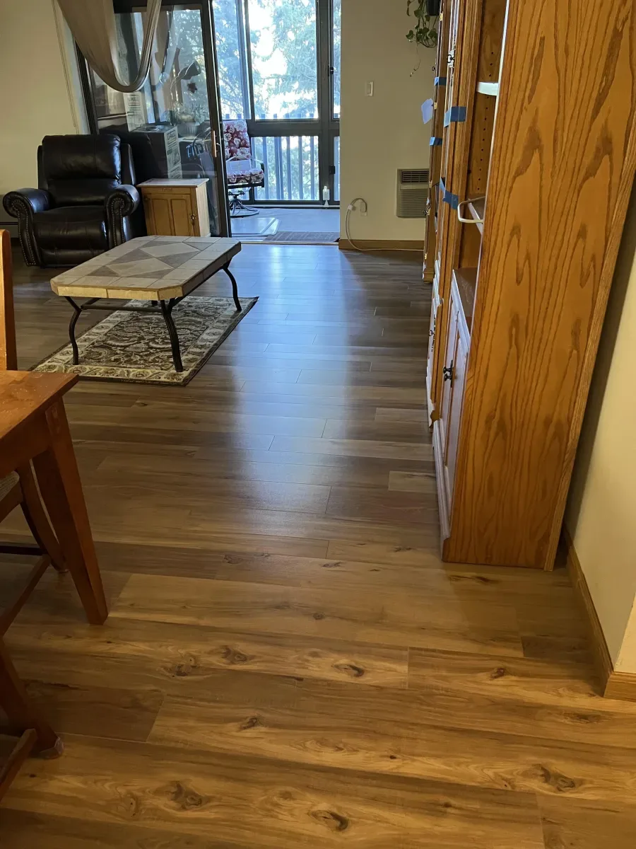 Wood flooring connecting a hallway and living room