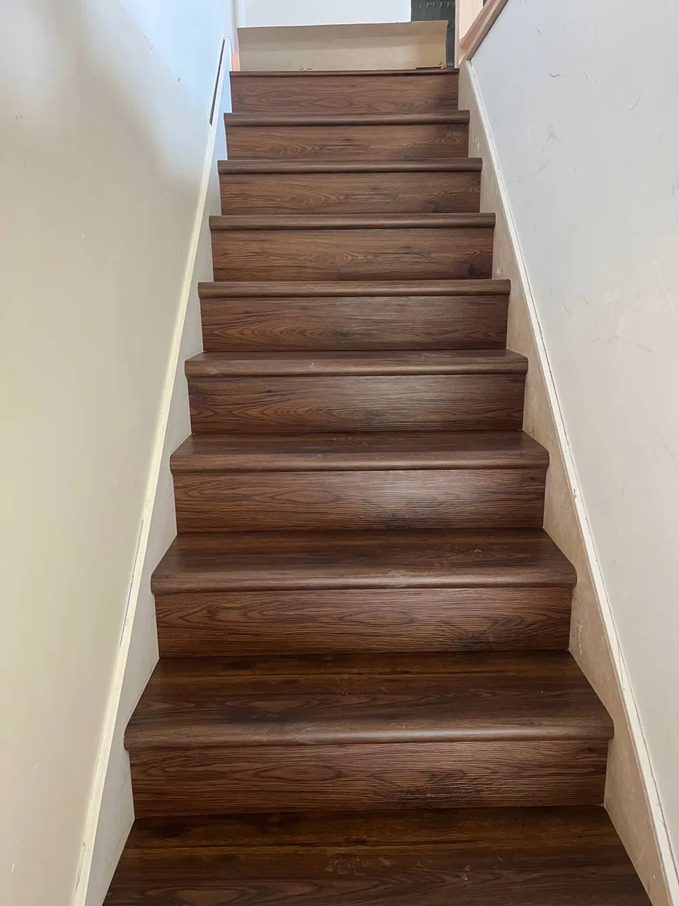 Finished wood stair treads with white walls