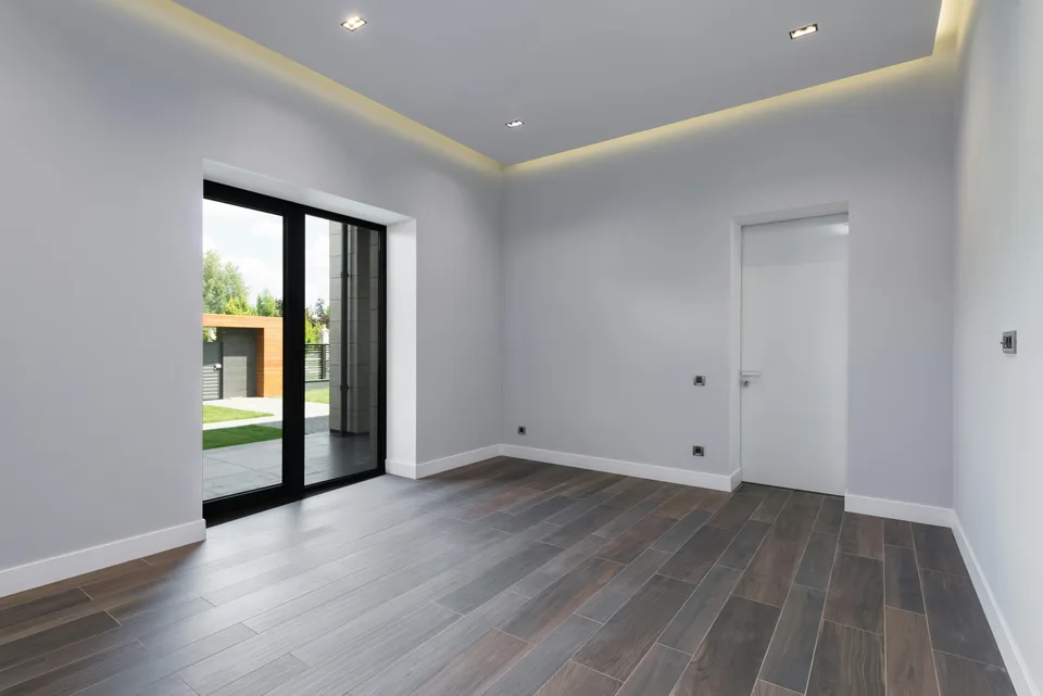 Dark plank flooring beside patio doors