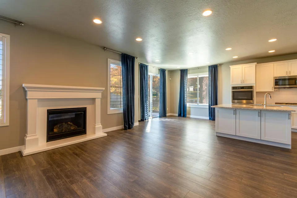 Brown plank flooring in a living room with a fireplace